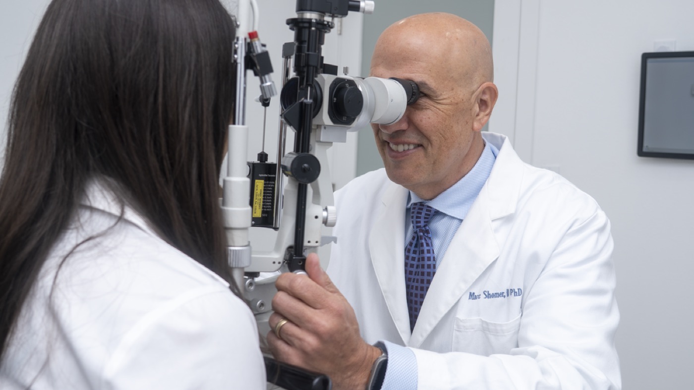 Dr. Marc H. Shomer performing a slit-lamp biomicroscopy examination in his ophthalmology office