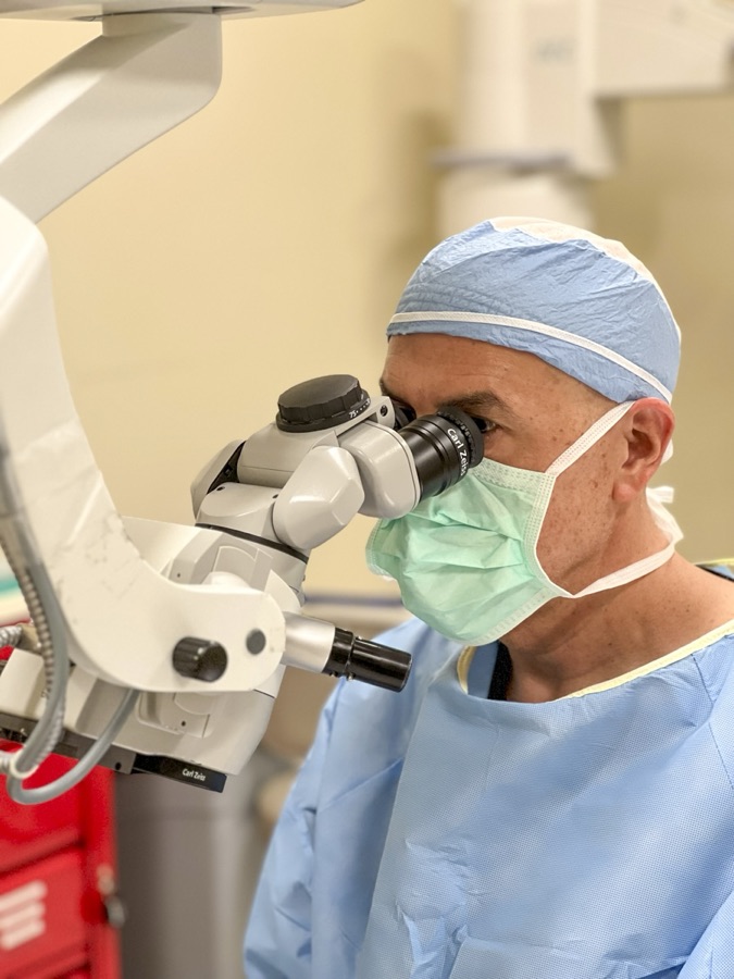 Dr. Marc H. Shomer at the operating microscope during ophthalmic surgery